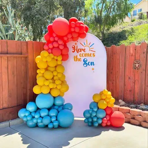 Cheerful "Here Comes the Son" Backdrop with Vibrant Balloons